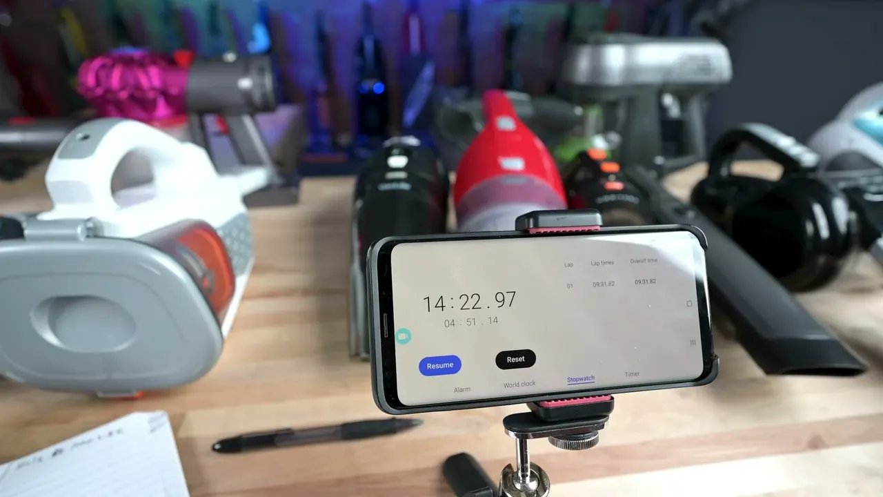 An owner times a charge on a stopwatch: the battery is the trade-off named most.