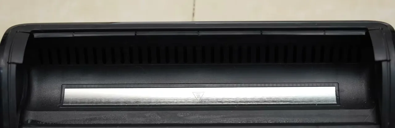 The dock's wash tray carries a wide metal heating strip, the part that heats water for the self-clean cycle.