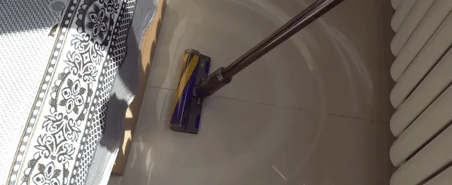 One pass clears tile dust; nothing dribbles back out of the head on lifting.