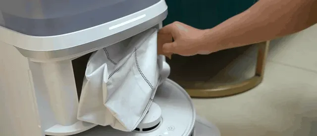 The dust bag is the consumable with the longest interval; here it hangs half out of its bay.