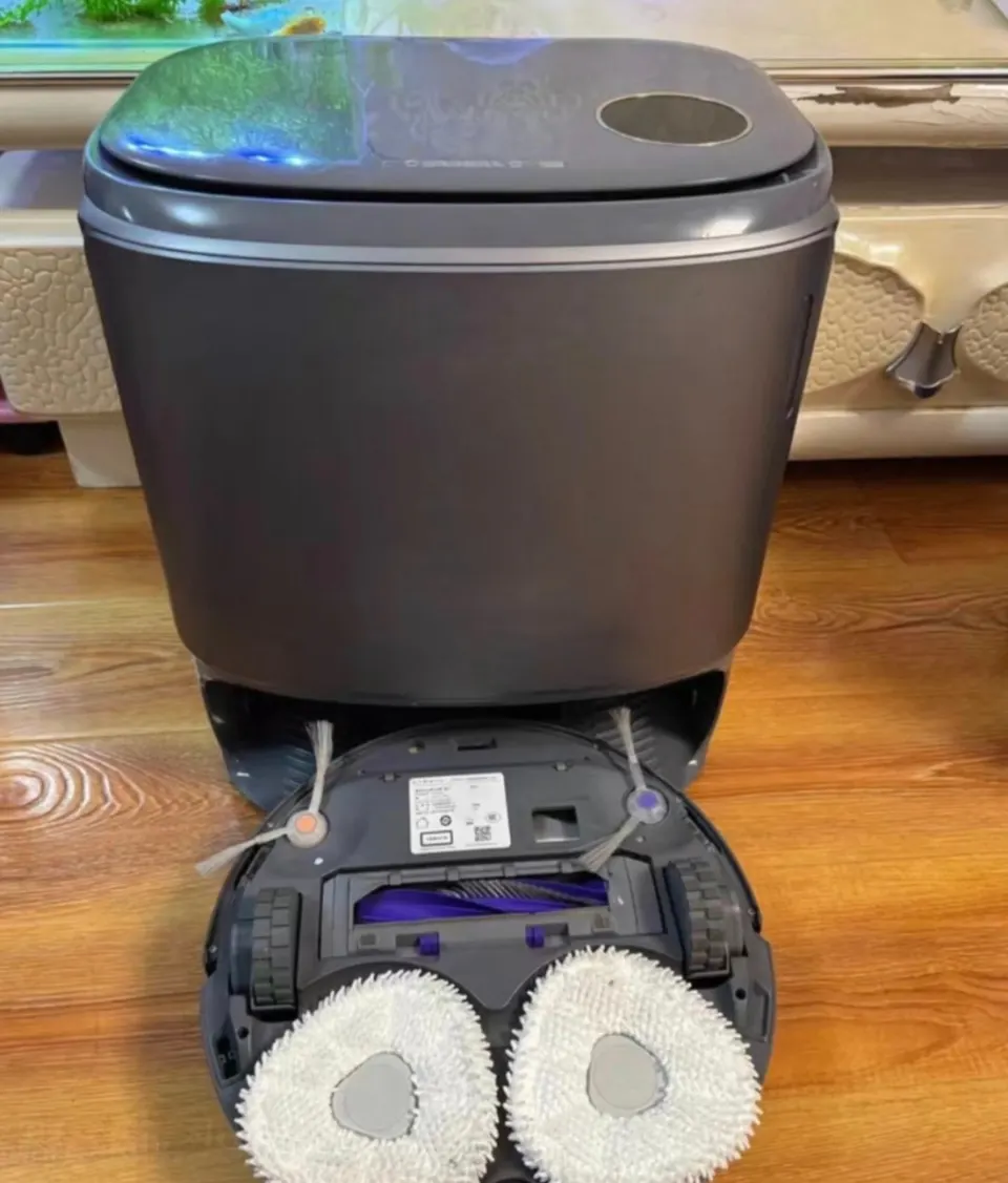 The mopping hardware is two spinning pads; on hard floors they press down with up to 12 N of force.