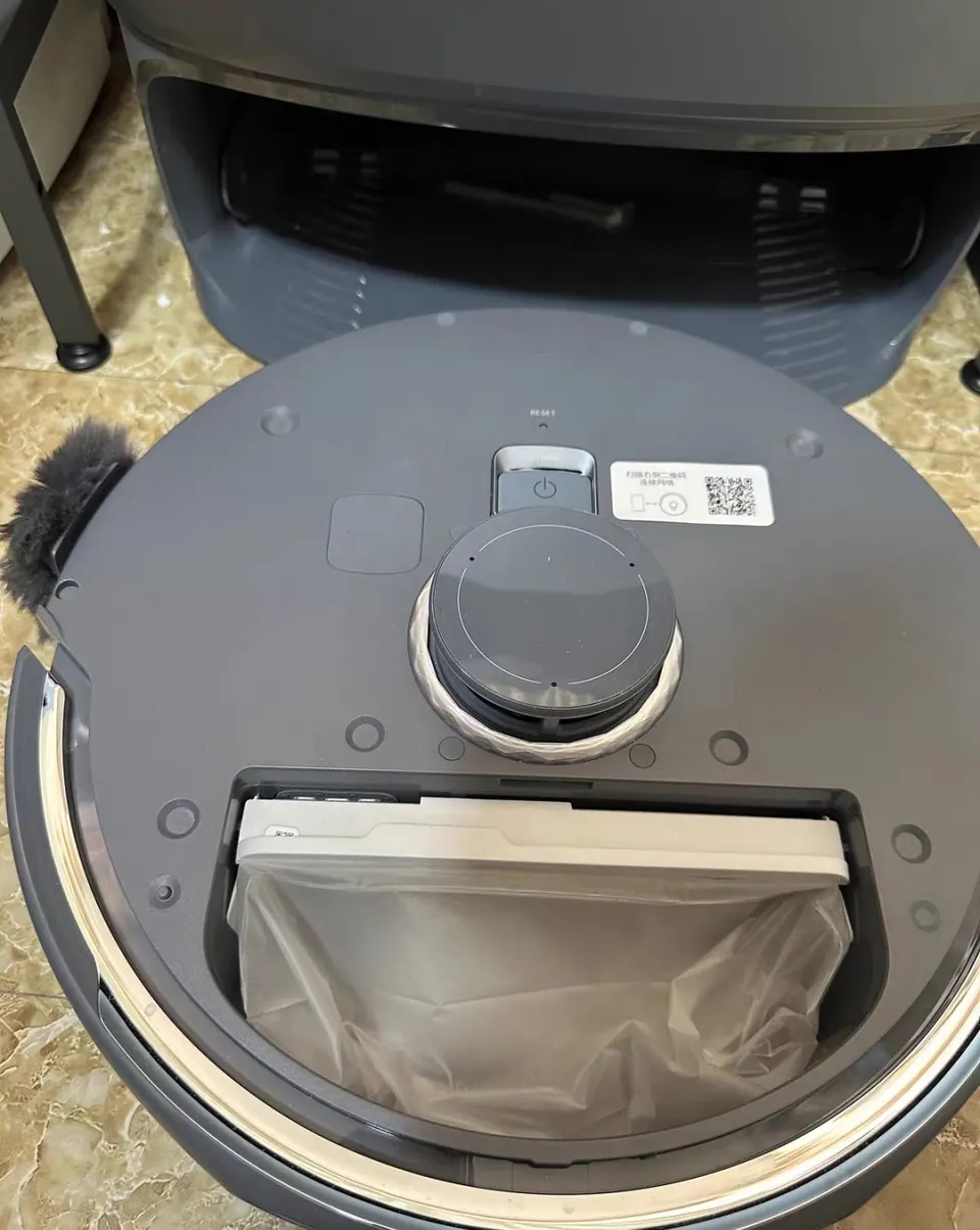 The onboard bin takes a disposable liner; when it is dirty you pull it out and drop in a new one.