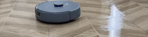 Dry debris gets vacuum-only treatment; here the robot closes in on a scattered powder patch.